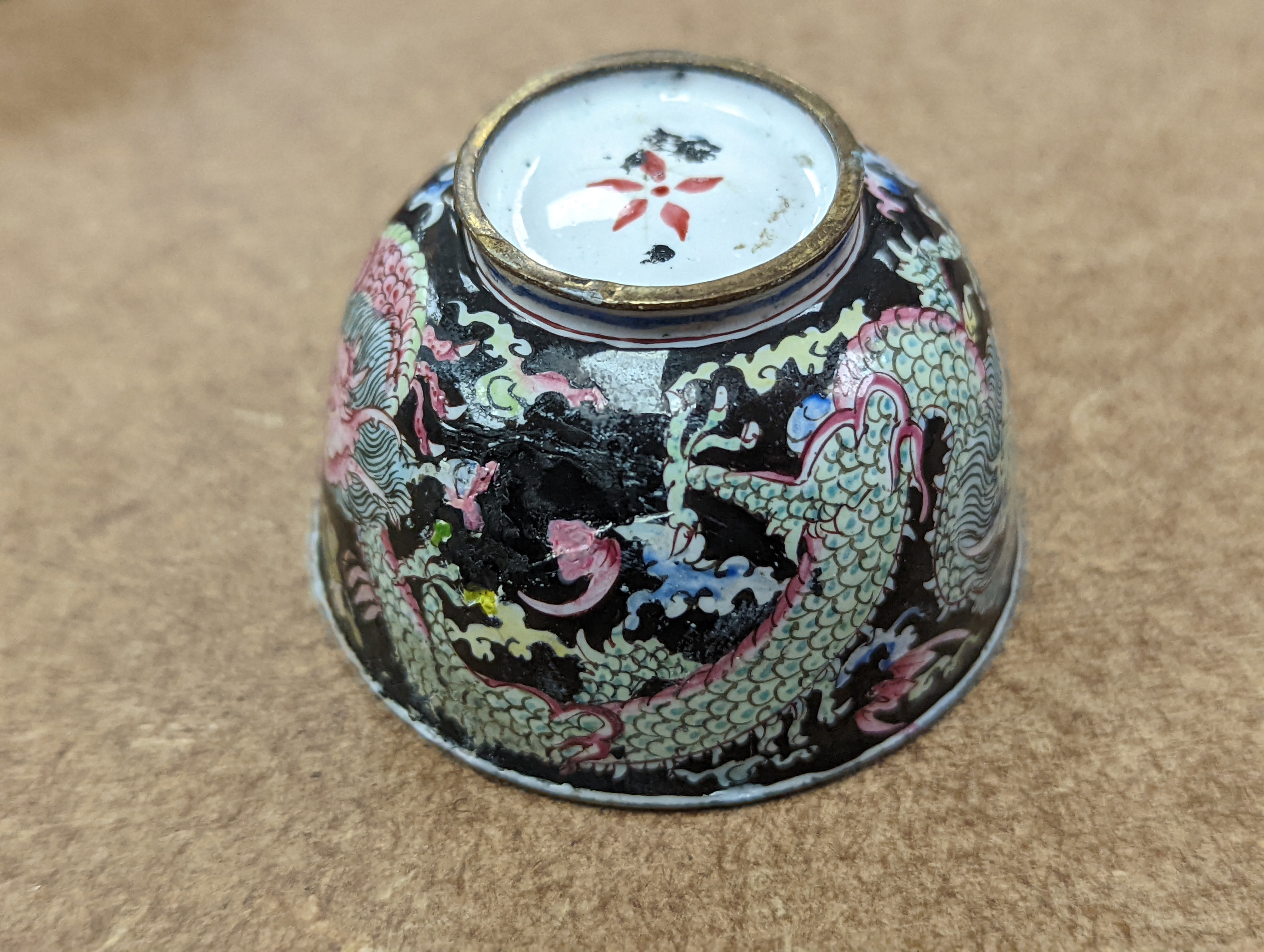 Two 18th century Chinese Canton enamel cups, and a 19th century Canton enamel oval snuff box, 5.8cm